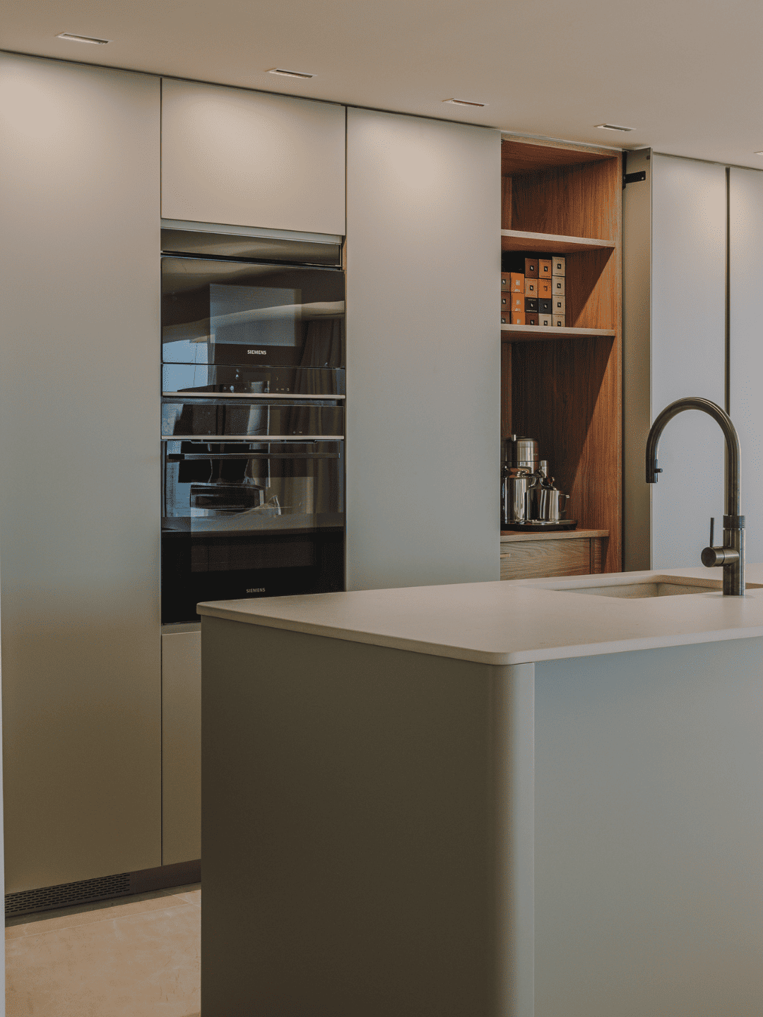 Cocina moderna con isla central en la que se ha utilizado tableros de madera DM laminada